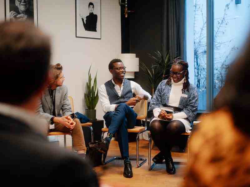 Photo of a man and a woman sitting in a workshop circle