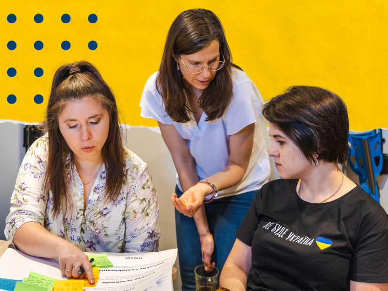 Three women working on buisness canva