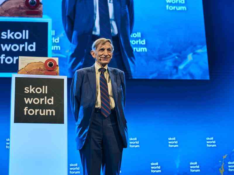 Bill Drayton facing audience front profile on stage at the Skoll Social Forum 2025