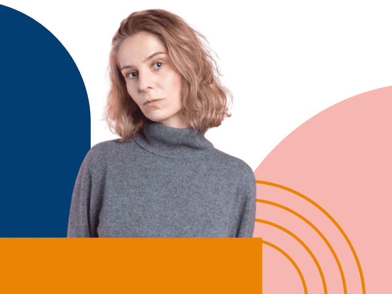 A woman in gray jumper and colorful geometrical shapes