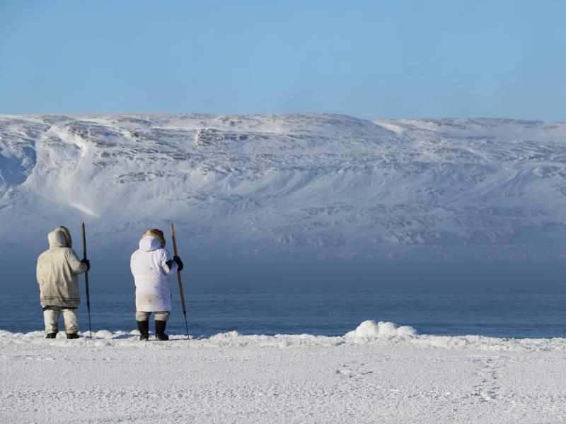 Hunters near Sanikiluaq involved in community-driven research programs; overlooking tundra and mountains