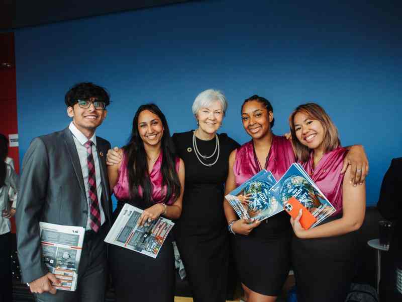 Group of students along with Laura Allan of Wilfrid Laurier University smiling at the camera