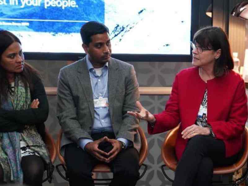 Group of people talking with each other; Janet Longmore at the right hand side