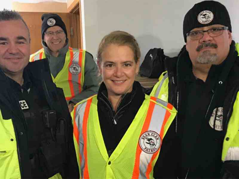 Three people dressed up in bright yellow patrol gear