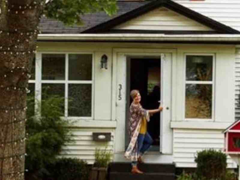 Person in front of their house opening the front door