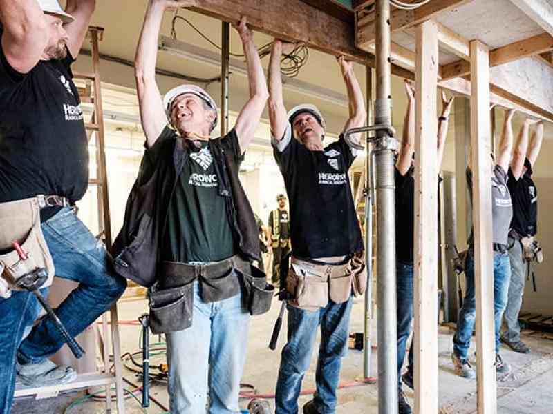 People working to build a building as part of HeroWork
