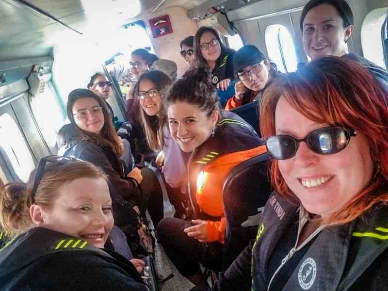 FOXY workshop participants and co-founder Nancy MacNeill board a plane to retreat 2018.jpg
